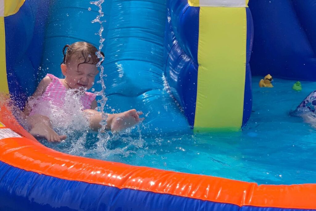 friends playing on bouncy castle at playground 1 scaled e1701776517679